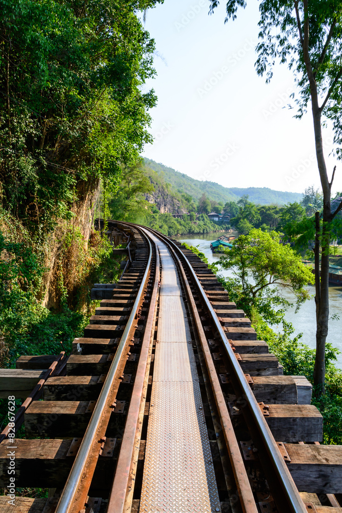 Train track with river and mountain view, railway in Thailand