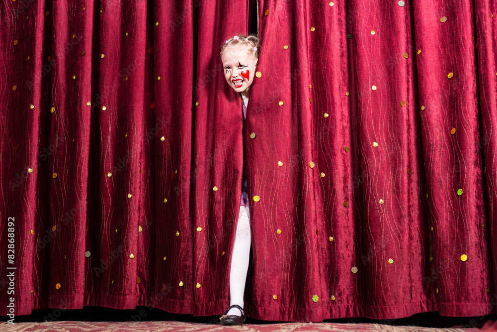 Laughing young girl making her entry on stage