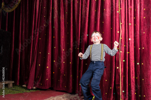 Exuberant little boy performing on stage
