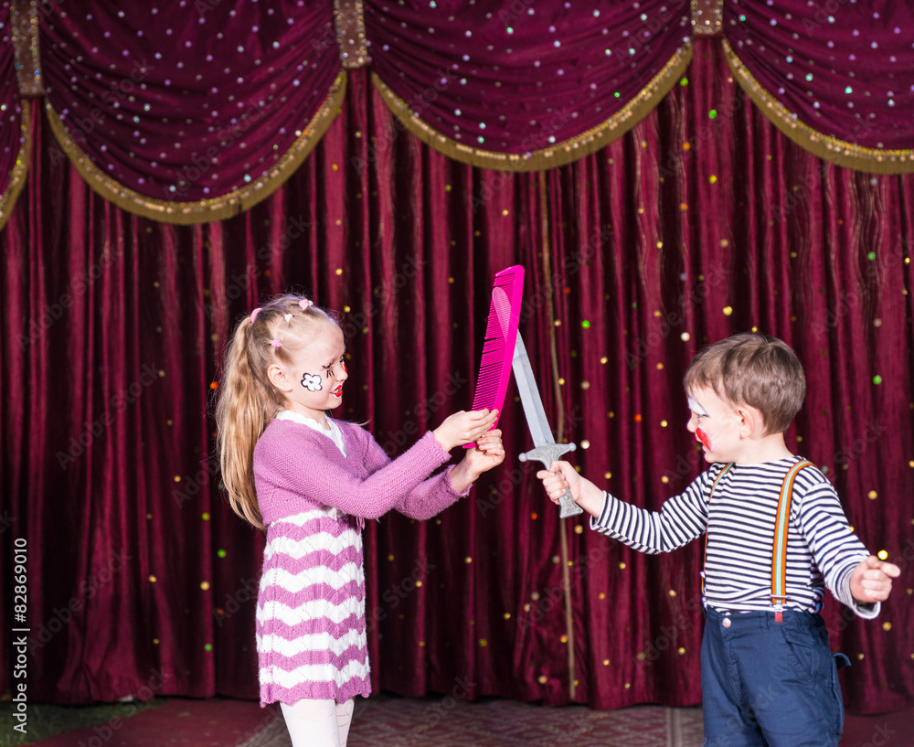Young Clowns Having Prop Sword Fight on Stage