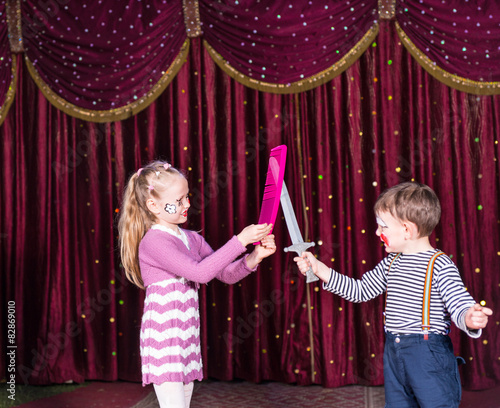 Obraz na płótnie Young Clowns Having Prop Sword Fight on Stage w salonie