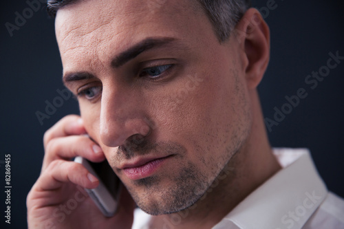 Pensive businessman talking on the phone