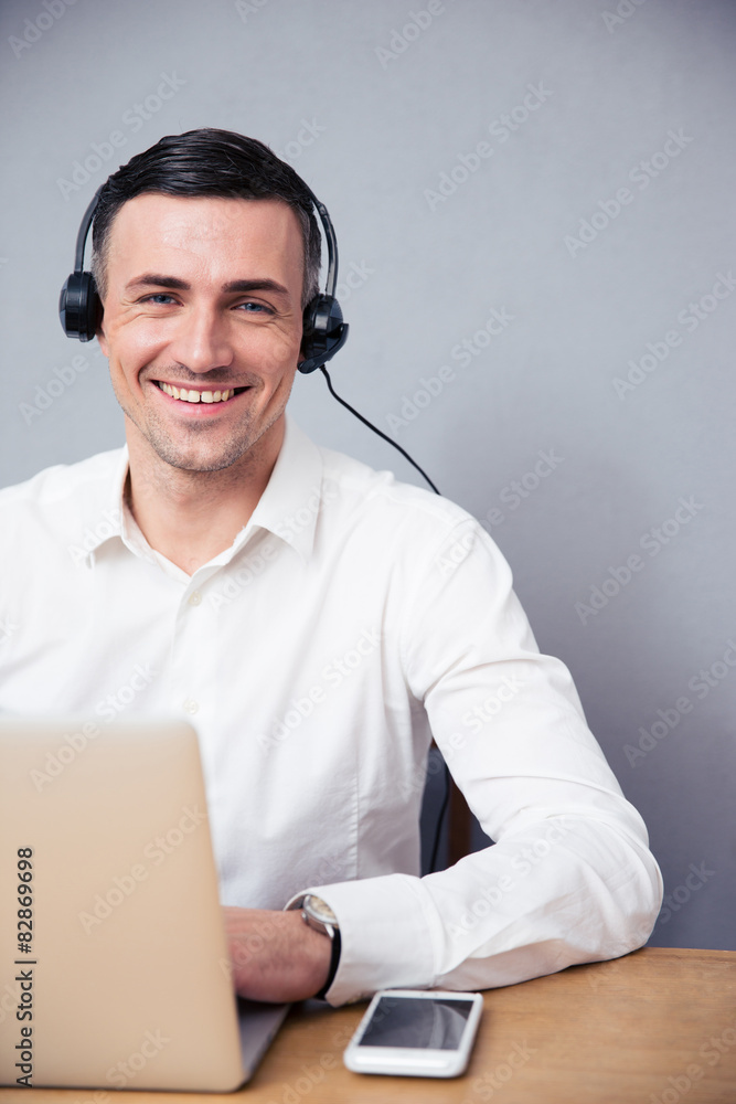 Smiling businessman with laptop and headphone Smiling businessman with laptop and headphone