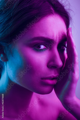 Beauty portrait of woman with colorful light
