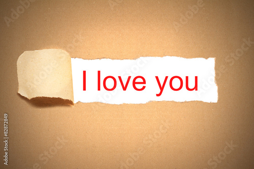 brown paper envelope torn to reveal i love you