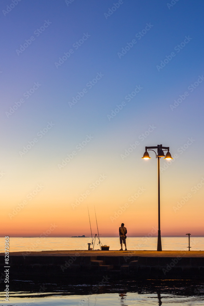 Man fishing on sea pier