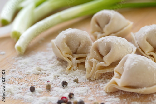 Homemade uncooked dumplings with meat photo