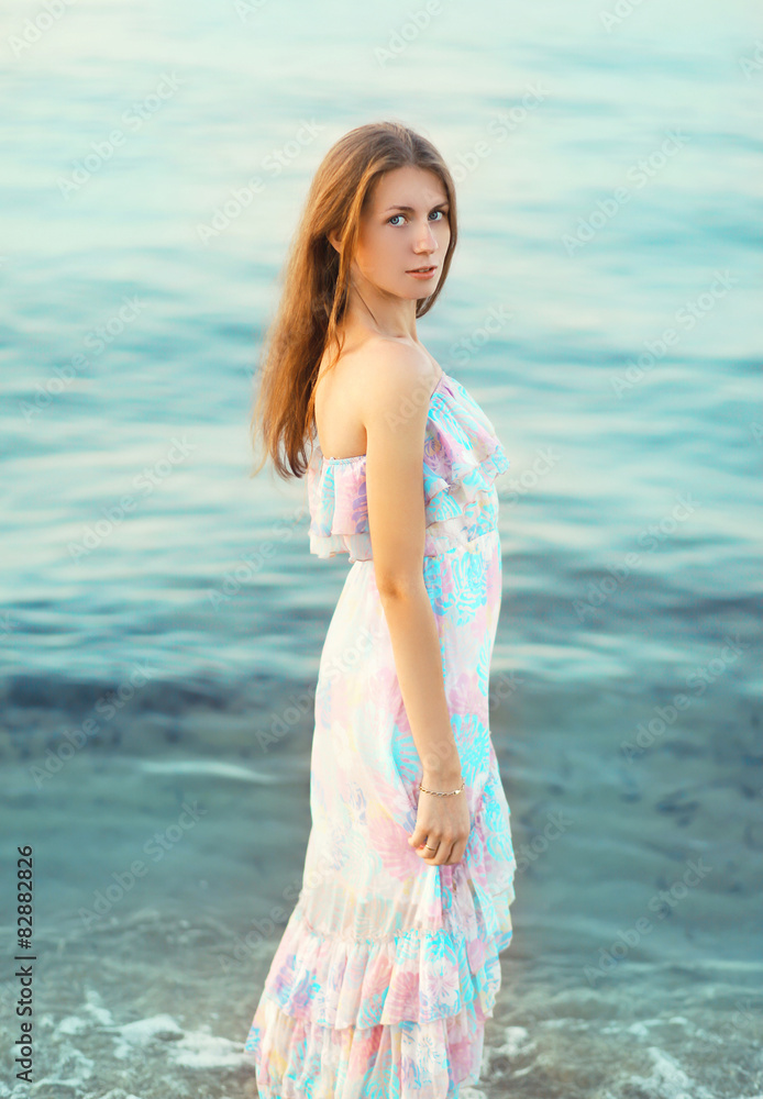 Portrait of beautiful young woman against the sea