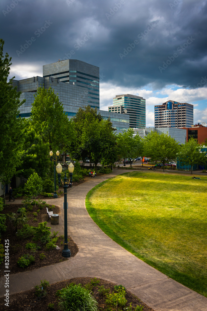 Walkway at Tom McCall Waterfront Park and buildings in Portland,
