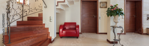 Corridor with elegant stairs and armchair © Photographee.eu