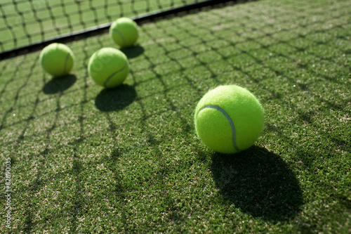 tennis balls on tennis grass court © kireewongfoto