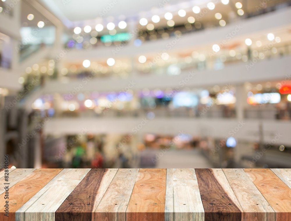 Empty wood table and blurred shopping mall background. product d