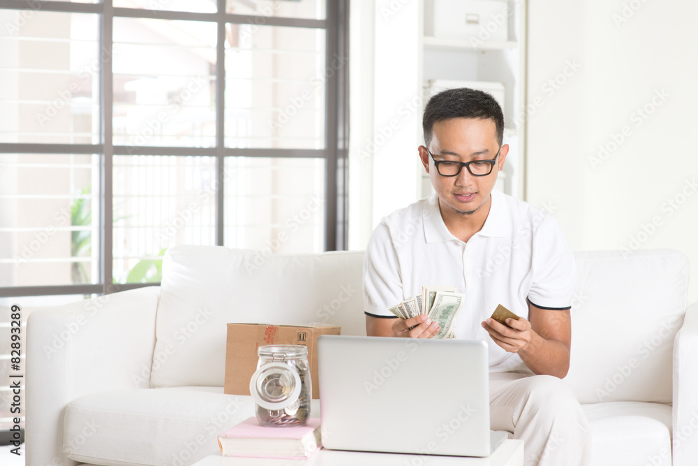 asian male enjoying cash back credit card