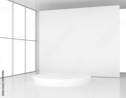 White room with a round pedestal