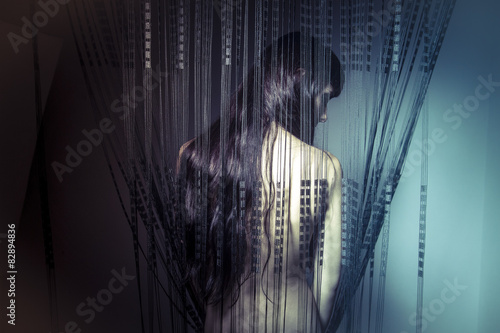 Skin, naked girl behind curtains of black threads