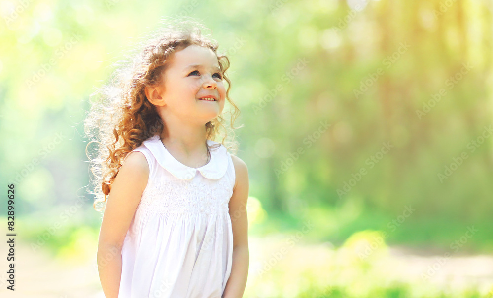 Portrait of charming curly little girl enjoying summer sunny day Portrait of charming curly little girl enjoying summer sunny day