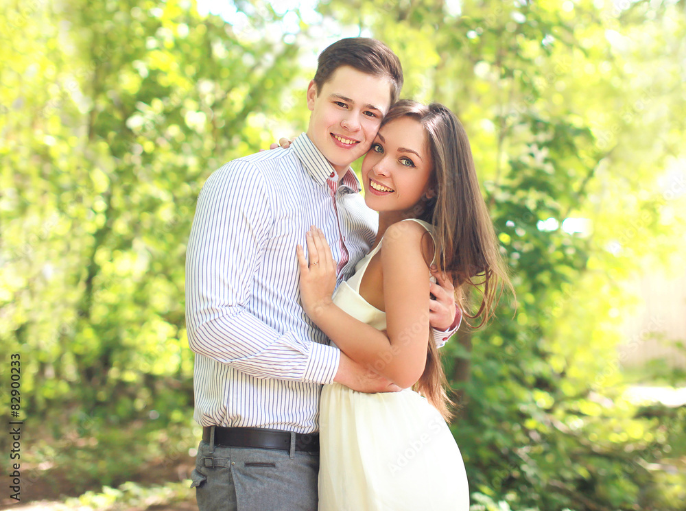Portrait of happy young couple together in sunny summer day