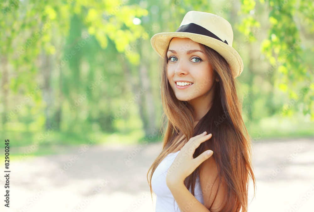 Summer portrait of beautiful young girl in hat on nature