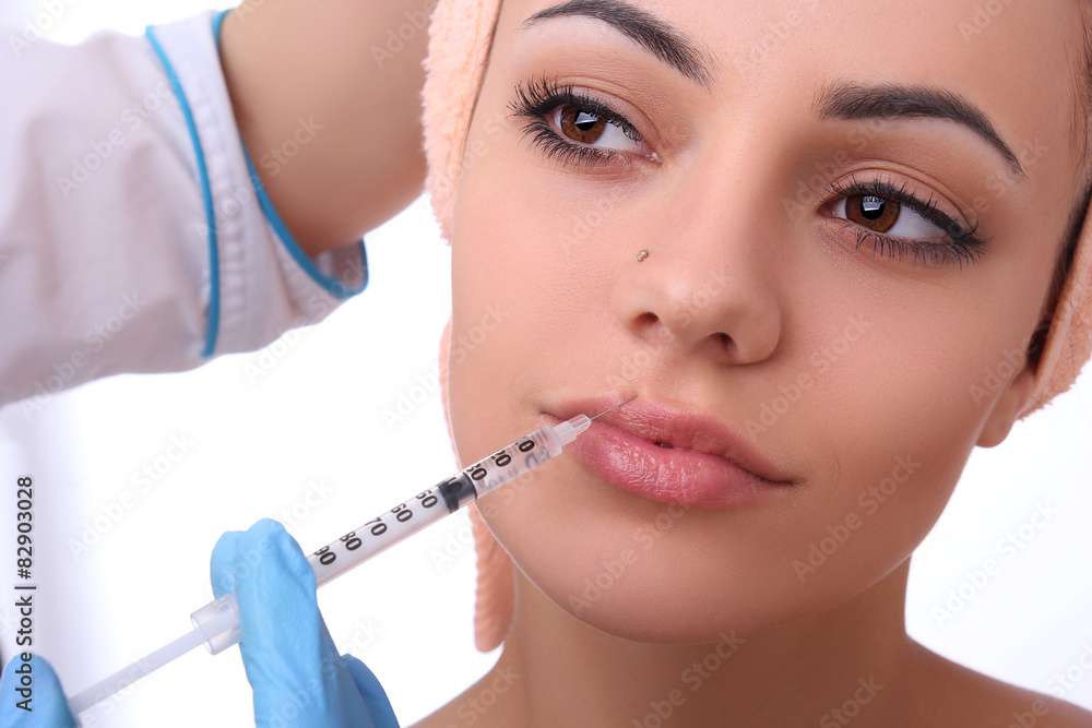 Beautiful woman gets an injection in her face. Beautiful woman gets an injection in her face.