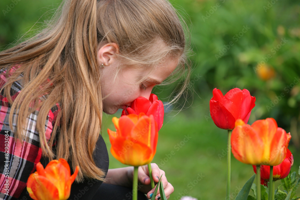 girl smelling flowers in the garden
girl smelling flowers in the garden