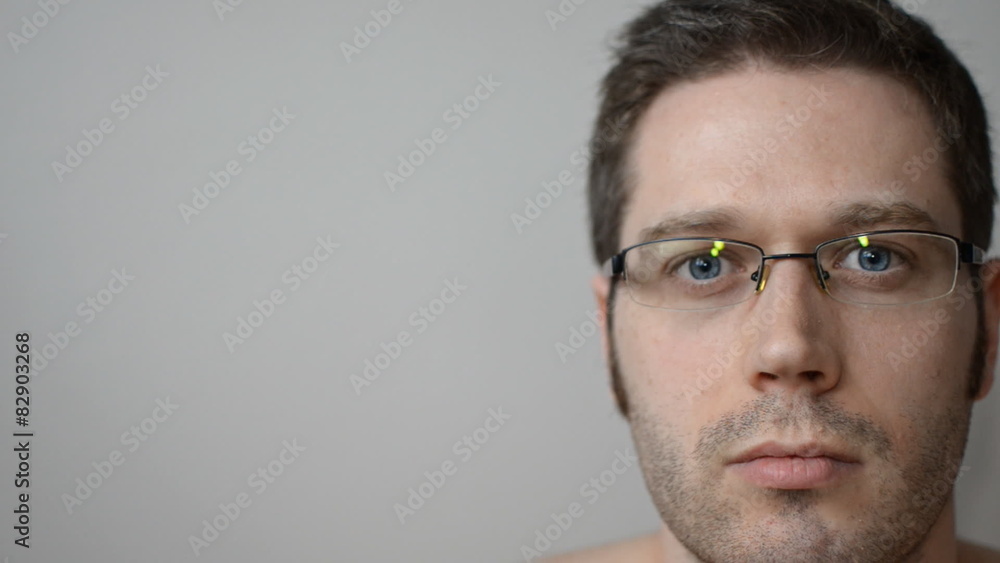 Man putting on and putting off glasses. Place for advertising. Man putting on and putting off glasses. Place for advertising.