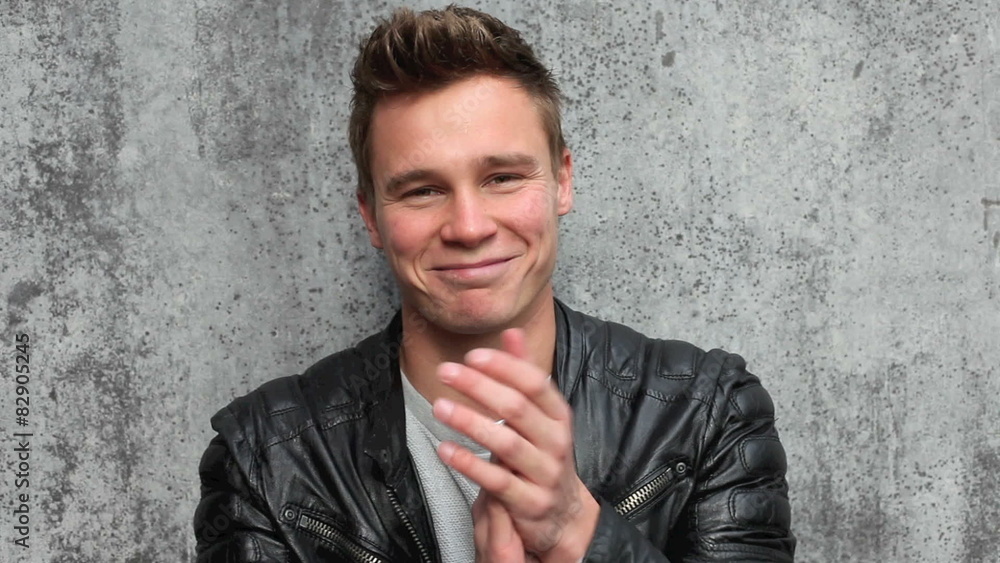 Casual young guy clapping hands Casual young guy clapping hands