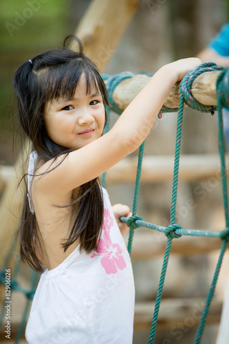 Happy asian cute Girl playing on playground