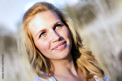 Portrait of a young, smiling beautiful woman in the summer sunsh photo