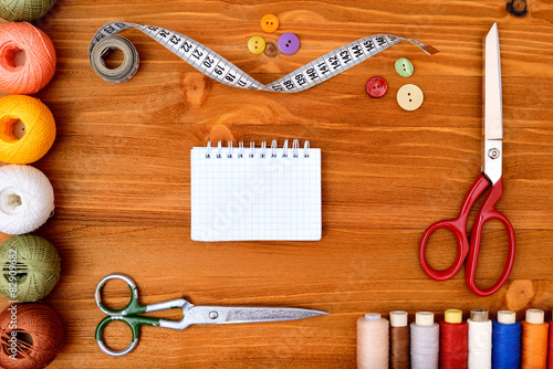 Copyspace frame with sewing tools on wooden background