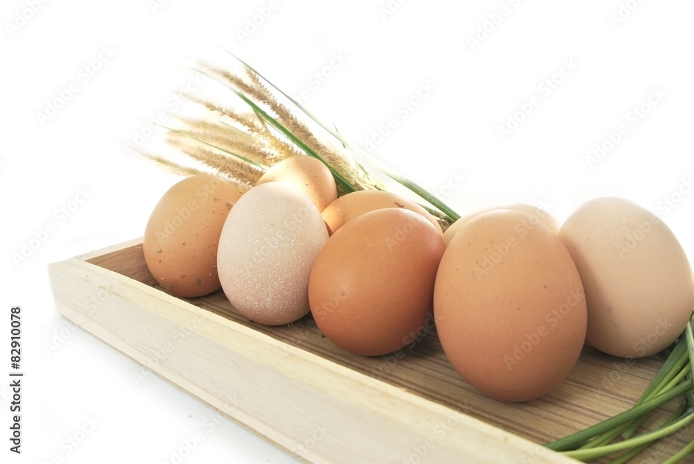 Eggs in wooden box and grass on white background Eggs in wooden box and grass on white background