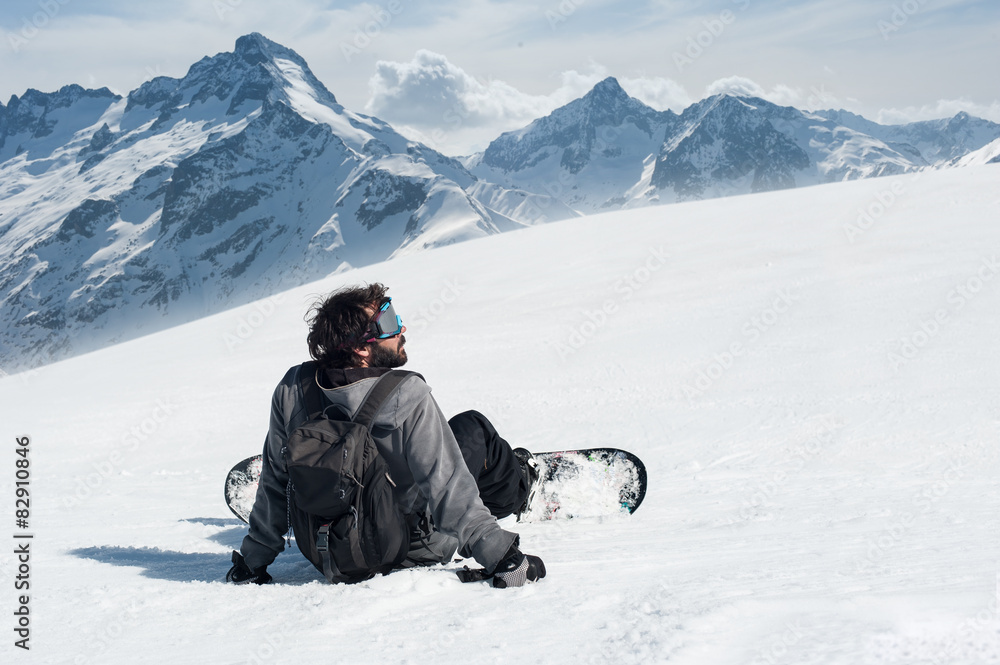 Snowboarder sit at top of mountain