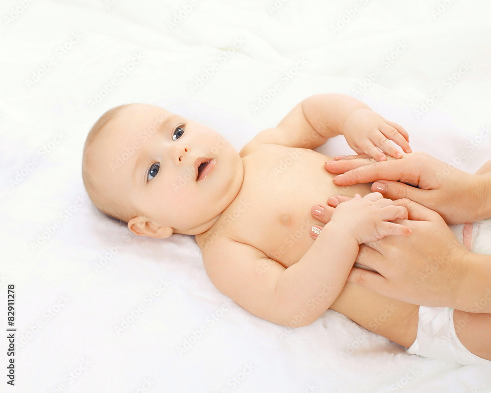 Baby massage lying on the back at home on the bed Baby massage lying on the back at home on the bed