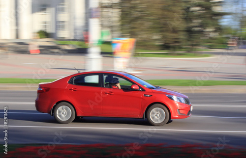 Red car on the street with the effect of blurring the day © leon134865