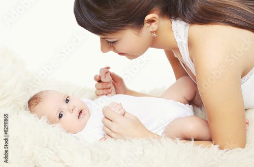 Portrait of cute baby with young mom at home, comfort