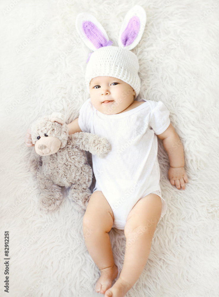 Soft photo of sweet baby in knitted hat with a rabbit ears and t Soft photo of sweet baby in knitted hat with a rabbit ears and t