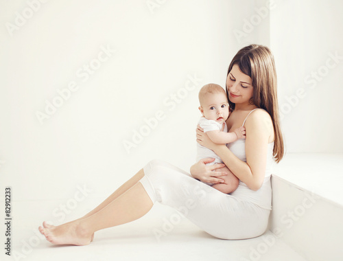Soft comfort photo young mother with baby at home in white room