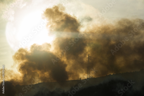 Fire with smoke and a giant sun on the background © Aurelio Wieser