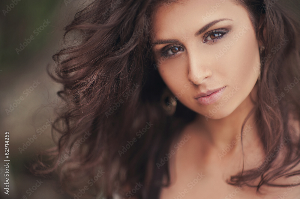 Portrait of a beautiful brunette girl on the nature Portrait of a beautiful brunette girl on the nature