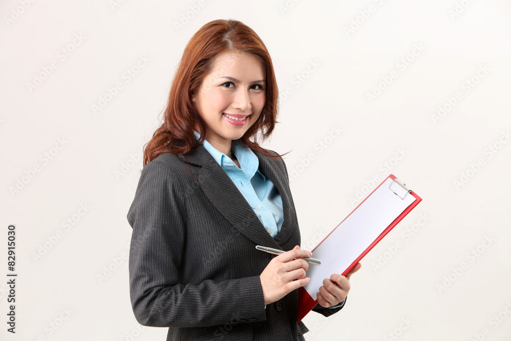 woman holding a clip board looking at camera woman holding a clip board looking at camera
