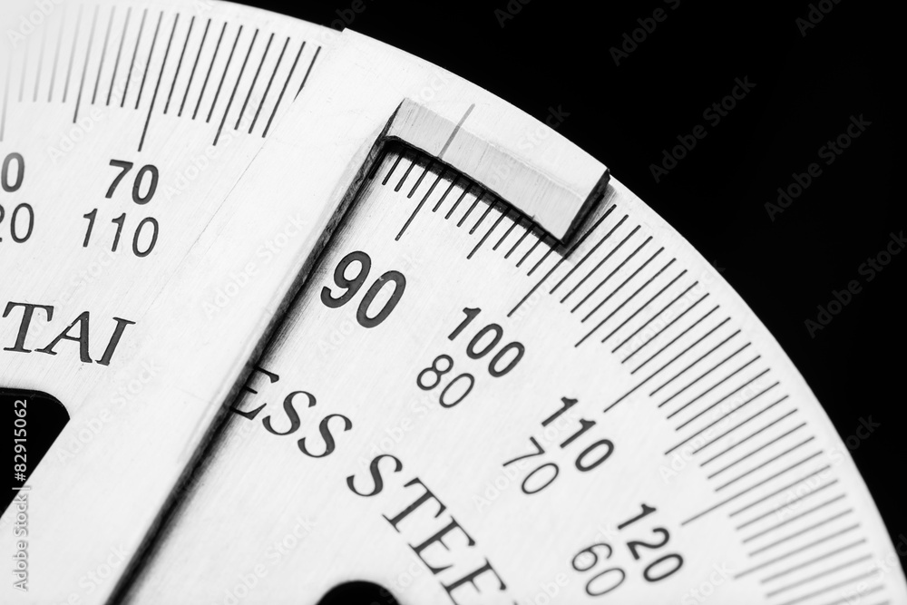 Metal protractor on black background close up photo Metal protractor on black background close up photo