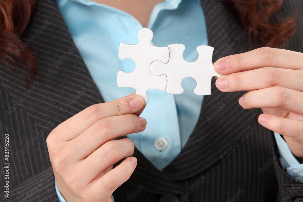 close up of woman holding puzzle pieces close up of woman holding puzzle pieces