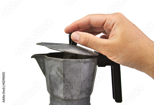 Man hand opening an old, used and rusty italian coffee maker