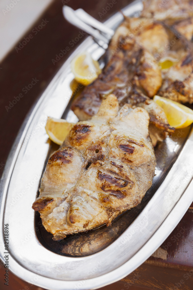 Grilled tuna fish on silver plate Grilled tuna fish on silver plate