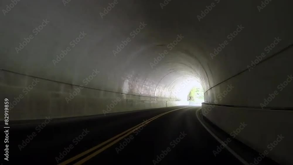 Car enters, drives through, and exits a tunnel Car enters, drives through, and exits a tunnel
