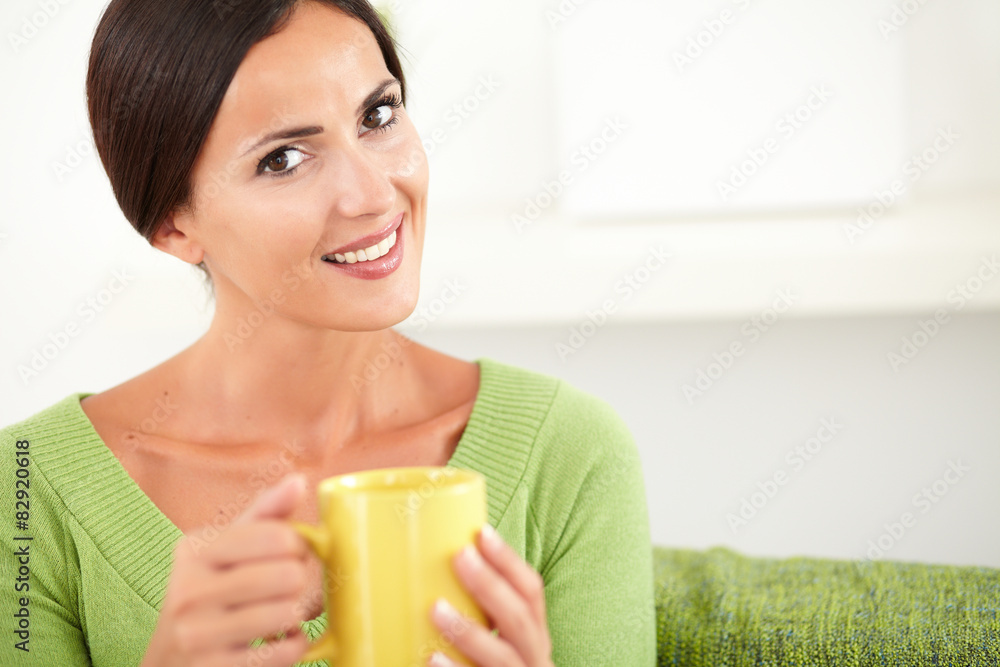 Relaxed woman sitting and looking at the camera Relaxed woman sitting and looking at the camera