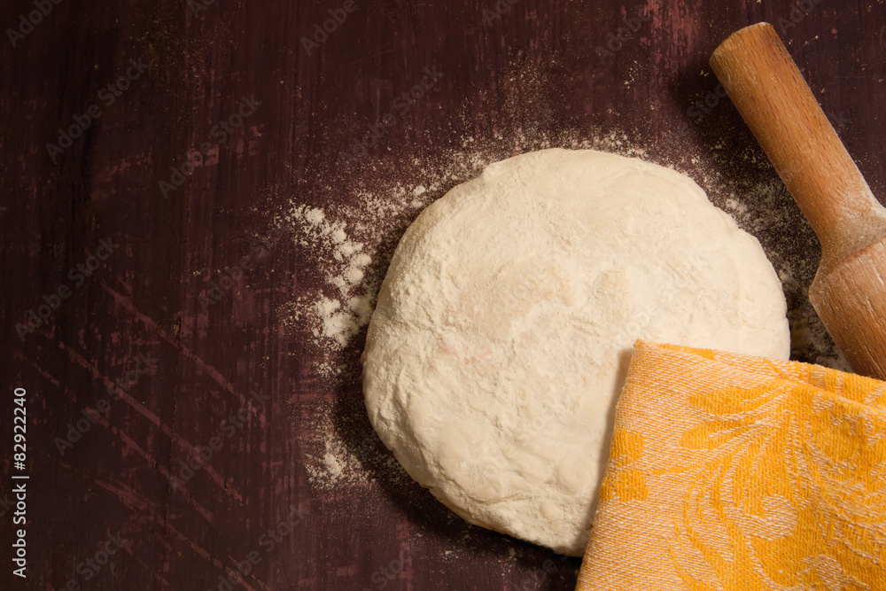 homemade baking. Fresh dough for pastry, spilled flour, kitchen rolling pin on a chopping Board homemade baking. Fresh dough for pastry, spilled flour, kitchen rolling pin on a chopping Board