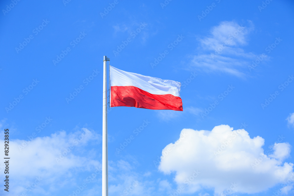 Polish flag on a background of blue sky Polish flag on a background of blue sky