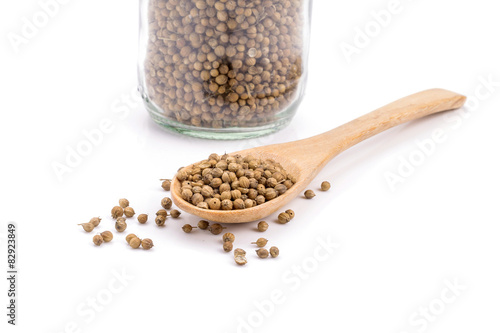 coriander seeds in a wooden spoon
