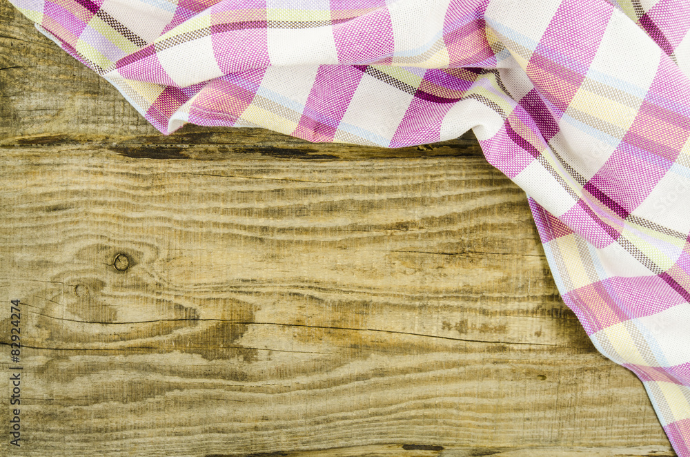 Folded towel over wooden table Folded towel over wooden table