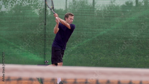 Professional Tennis Player Hits The Ball And Expresses Achievement